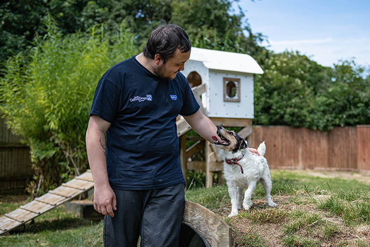 Staff and dog in the enrichment garden 