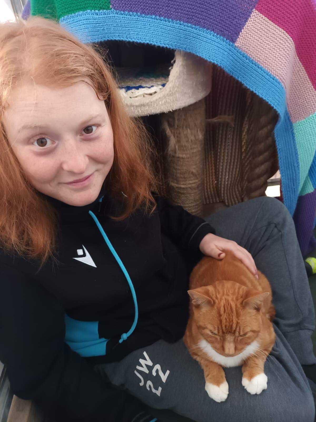 Volunteer Jess with cat Ted as part of her cattery care role 