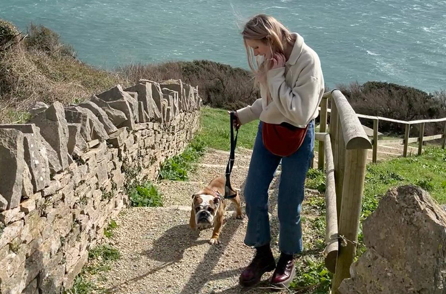 Zoe with her foster dog Buttercup out on a coastal walk 